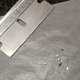 Shaving lead flakes off a fishing weight to test for lead removal
